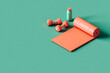 © Giada Canu/Stocksy - water bottle, fitness mat, dumbbells. fitness concept.
