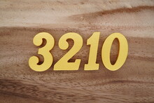 Golden Arabic Numerals On A Real Brown And White Wooden Floor Number 3210