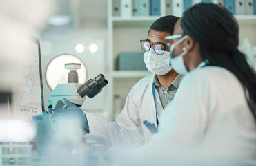 science enhances critical thinking. shot of two scientists working together on a computer in a lab.