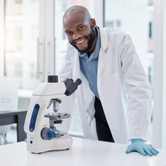 Wall Mural - Science and everyday life cannot and should not be separated. Shot of a young scientist using a microscope in a laboratory.