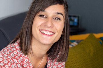 Wall Mural - Portrait of young brunette woman smiling