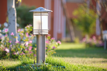 Outdoor lamp on yard lawn for garden lighting in summer park