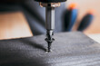 © Jannissimo - Screw screwed into timber wood on wooden top table background. Electric Screwdriver or drill screwing screw, nail or bolt into wooden planks. Repair furniture, carpenter working
