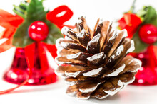 Single White Tipped Pine Cone With Shiny Red Bells