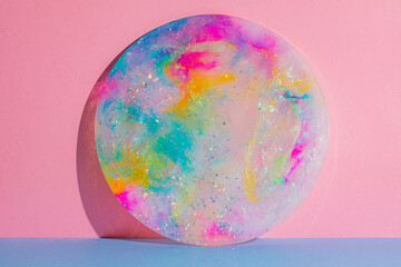 round circle colourful platter plate on pink and blue background