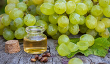 Grape Seed Oil In A Glass Jar And Fresh Grapes For Spa And Body Care. The Concept Of Spa, Bio, Eco Products.