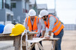 © visoot - Yellow,white and blue hard safety helmet hat for safety project of workman or engineer in construction site.