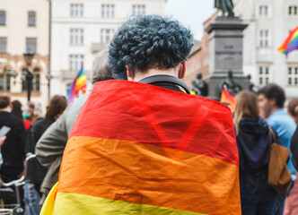 Wall Mural - Woman with rainbow flag during Krakow Equality March (Pride parade) at Main Market Square. Symbol of the LGBT community.