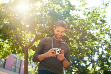 Sticker - These are some great shots. Cropped shot of a handsome young man taking photographs during his morning commute.