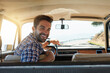 © Nola Viglietti/peopleimages.com - Comfortable back there. Rearview portrait of a handsome man enjoying a summer roadtrip.