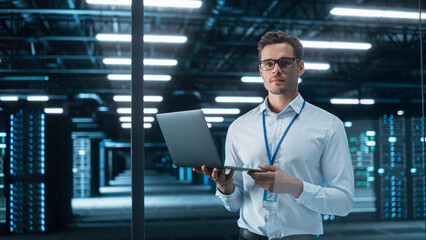 successful creative director working on laptop computer in big city office late in the evening. male