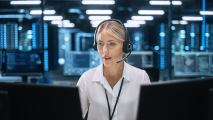 Fototapete - Busy Caucasian Woman Customer Service Support Agent in Headset Talking with Client and Looking at the Screen while Working at Call Center. Manager on Conference Video Call Consulting Client Online