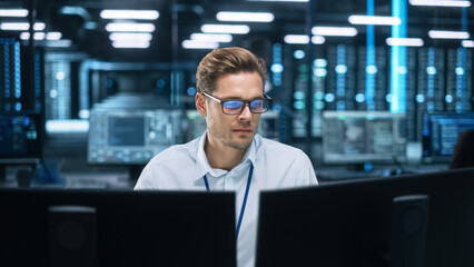 Poster - Focused System Administrator or Consultant Look at the Screen and Saves Backup Data in Dark Evening Room Workplace Station Indoors. Network Technologies Concept
