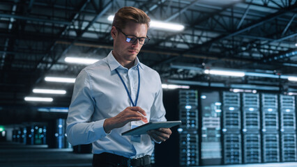 Late at Night in Private Office Businessman Looking Away while Works on a Laptop. Succesful Businessman and e-Business Entrepreneur Overlooking Server Farm Cloud Computing Facility