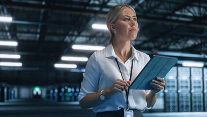 Fototapete - Young Caucasian Female Employee Uses Tablet Computer in System Control Monitoring Center at Night. Evening Office In the Background. Cyber Security and Network Protection Concept