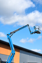 Cherry Picker Lift Platform With Telescopic Arm On A Building Site To Reach High Up In Construction Industry