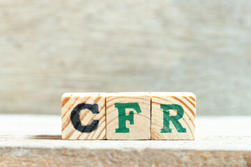 Sticker - Alphabet letter block in word CFR (abbreviation Cost and freight) on wood background