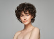 © kiuikson - Portrait of woman with curls isolated on gray background