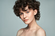 © kiuikson - Close-up face of young woman with short curls and fresh skin