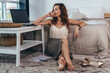 © undrey - Portrait of businesswoman sitting on floor in bedroom