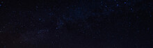 Panorama, Blue Night Sky, Milky Way And Stars On A Dark Background, Universe Filled With Stars, Nebula And Galaxies With Noise And Photo Pigmentation By Long Exposure And White Balance Selection Focus