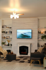 Wall Mural - Cozy living room interior with comfortable sofa and decorative fireplace