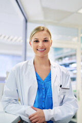 Poster - She has the answers to you wellness questions. Portrait of a happy young woman working in a pharmacy.