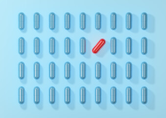 Patterns of blue medicine capsules with a red one, top view