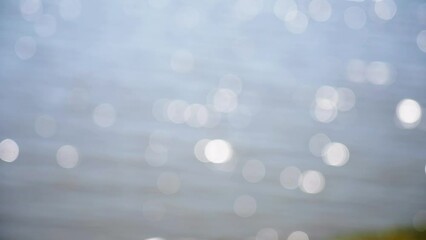 lens flare bokeh of sun reflections in lake water