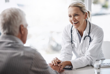 Sticker - Im glad to see youre in such great health. Cropped shot of a mature female doctor working with a senior male patient in her office in the hospital.