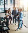 © Delmaine Donson/peopleimages.com - This project is gonna require all of us. High angle shot of a group of young designers talking in their office.