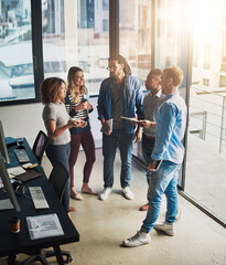 Aufkleber - This project is gonna require all of us. High angle shot of a group of young designers talking in their office.