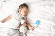 © Pixel-Shot - Adorable little child with toy and baby monitor sleeping on bed