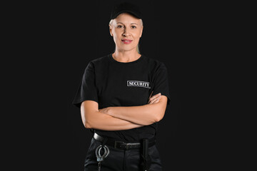 Wall Mural - Female security guard on dark background