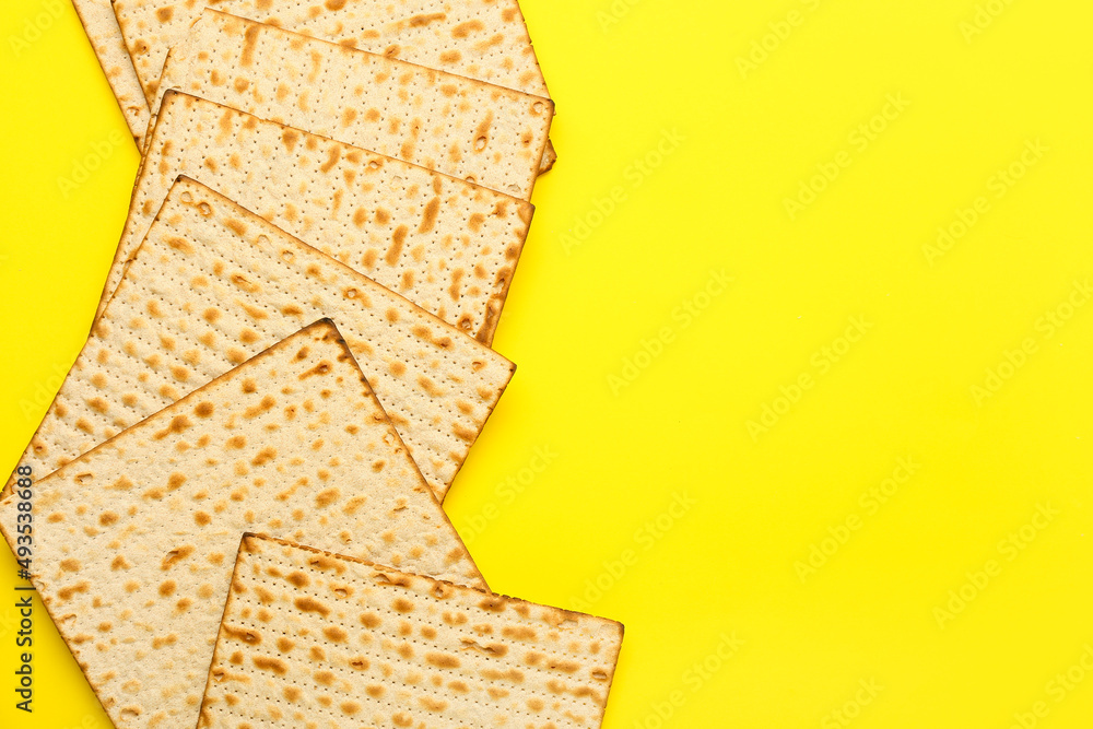 Jewish flatbread matza for Passover on yellow background