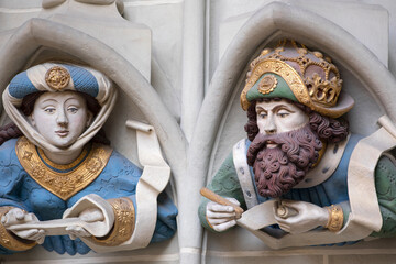 Stone relief by entrance of Swiss medieval cathedral in Bern. Decoration of facade of evangelical church in Bern. Gothic sculptures, architectural elements of Bern minster.