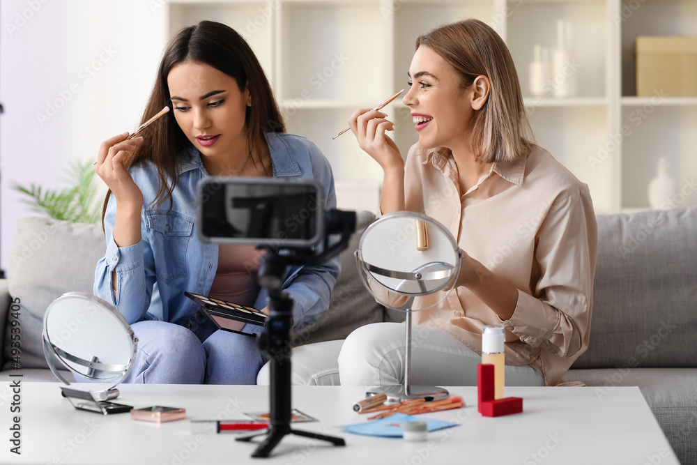 Young female beauty bloggers recording video in studio