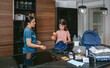 © David Pereiras - Mother explaining to her daughter how to prepare an emergency backpack in the kitchen