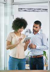 Aufkleber - Let me show you what I found online. Shot of two coworkers using a digital tablet together in the office.