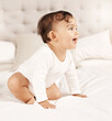 © Nicholas F/peopleimages.com - Shell turn any frown upside down. Shot of an adorable baby girl sitting on a bed.