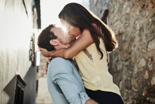 You know just how I want to be kissed. Shot of an affectionate couple kissing outside.