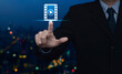 © grapestock - Businessman pressing play button with movie flat icon over blur colorful night light modern city tower and skyscraper, Business cinema online concept