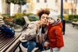 © Dusan Petkovic - A playful little boy blowing bubbles at the park with his nanny.