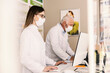 © Dusan Petkovic - Focused female pharmacist with mask using computer for data entry at pharmacy.