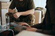© Drazen - Close up of nervous military man having counseling with mental health professional.