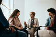 © Drazen - Mature therapist talks to members of group therapy during meeting at mental health center.
