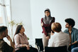 © Drazen - Young sad Muslim woman shares her problems during group therapy meeting.