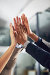 © Jadon Bester/peopleimages.com - One team working towards one dream. Closeup shot of a group of colleagues giving each other a high five in an office.