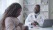 African-American male obstetrician consulting anxious pregnant woman, check-up