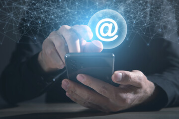 Wall Mural - male hand showing smartphone with a email symbol.